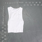 White tank top on a gray background with measurement scale