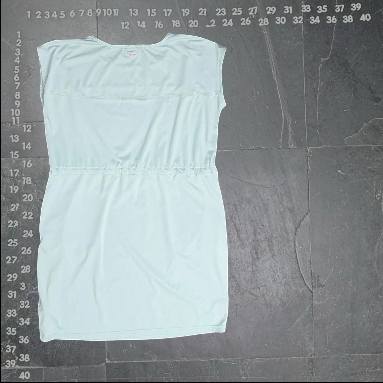Columbia spray green sleeveless drawstring waist dress. Lightweight, breathable, and adjustable silhouette for versatile wear.