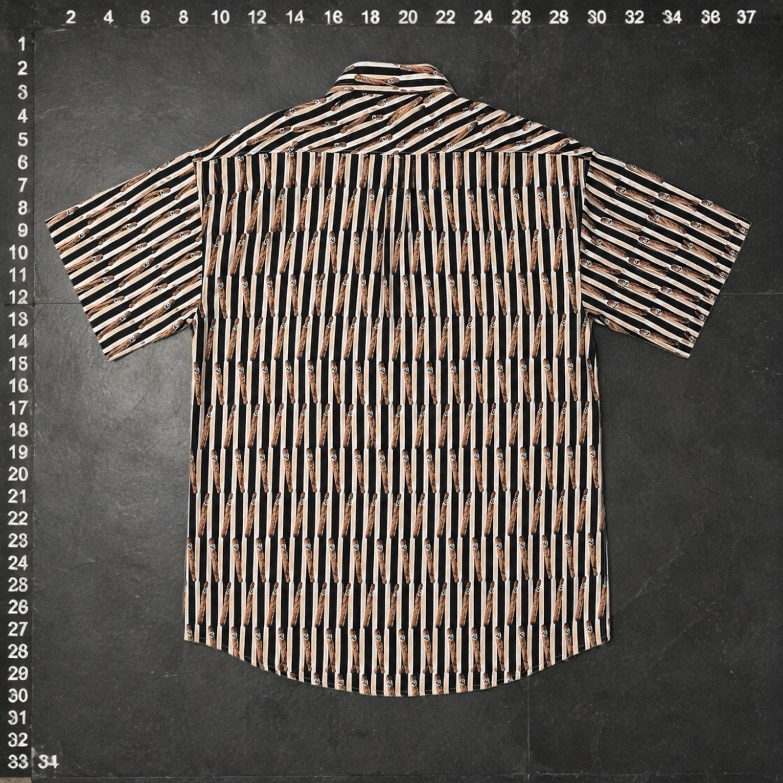 O.M.THRIFT vintage short sleeve button down shirt with an all-over cigar graphic print and vertical stripes.