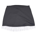 The Room Collective black mini skirt with white ruffled hem. High-waisted, slim fit, stretchy polyester/spandex blend with cotton ruffle.
