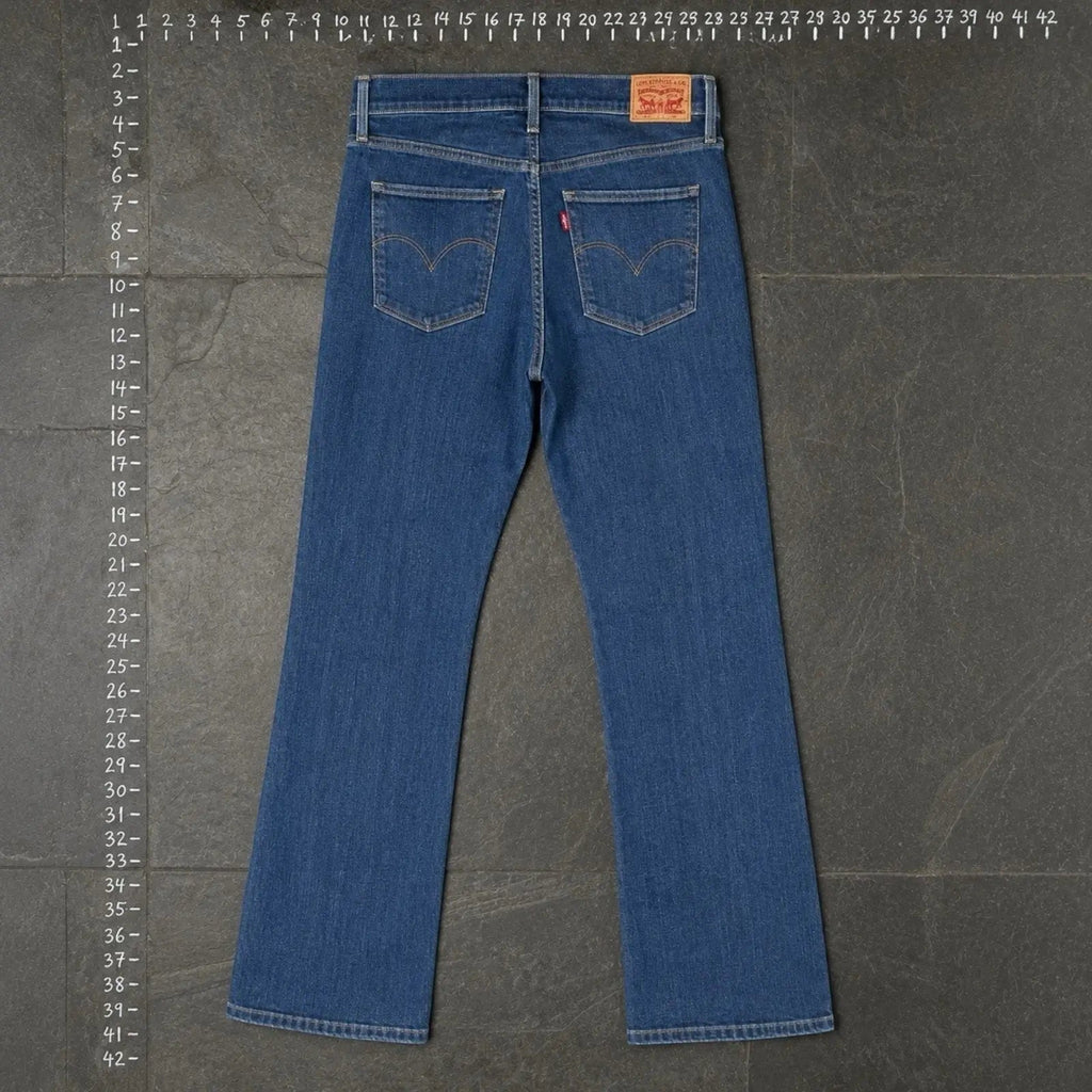 The Room Collective Levi's Women's Bootcut Denim Jeans in mid-blue wash denim. Features a mid-rise waist and classic five-pocket styling.
