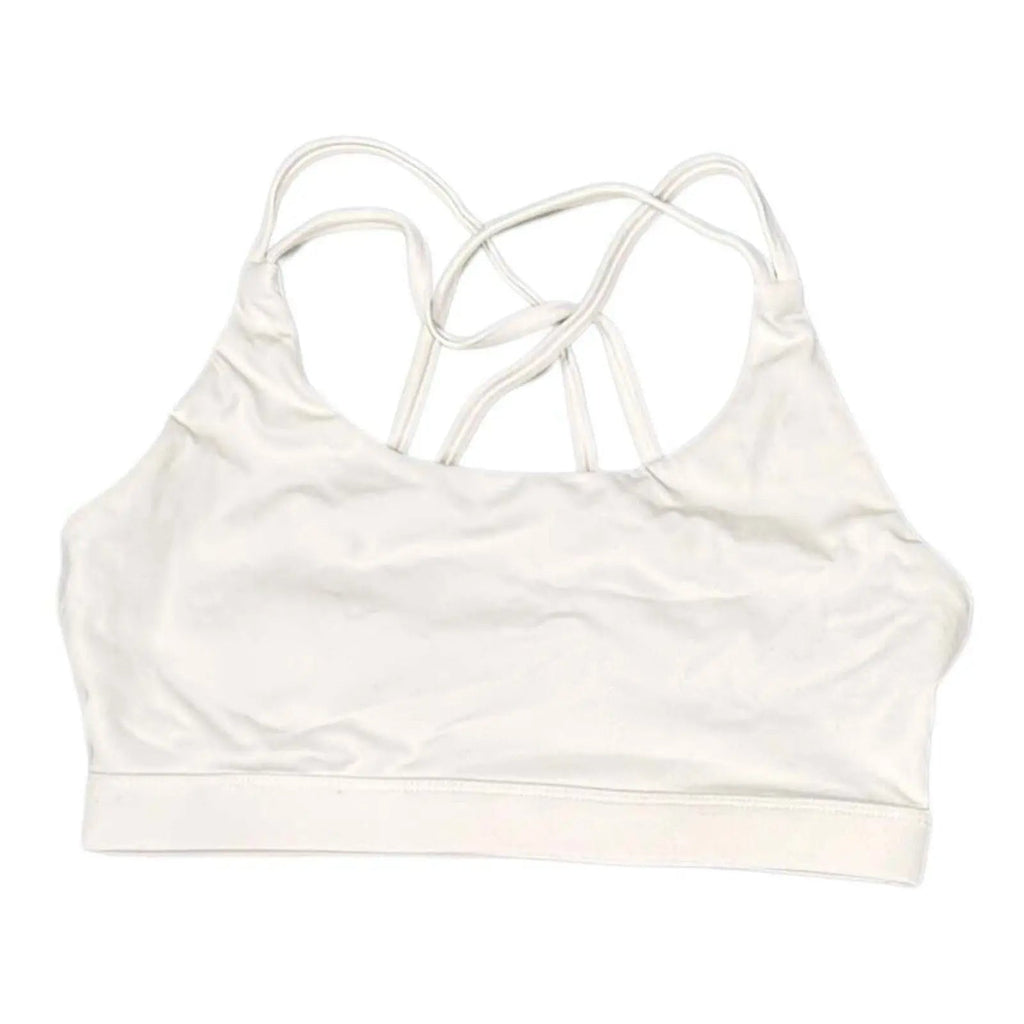 The Room Collective white Lululemon Free to Be Serene bra with strappy back detail, size M. Light support for yoga.