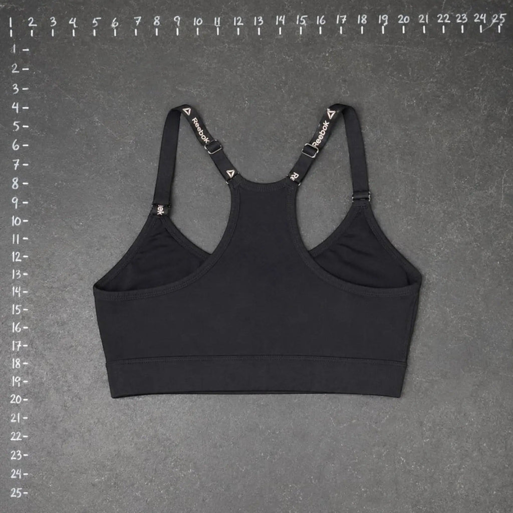 The Room Collective Reebok black logo strap sports bra, size S. Racerback design with adjustable straps.