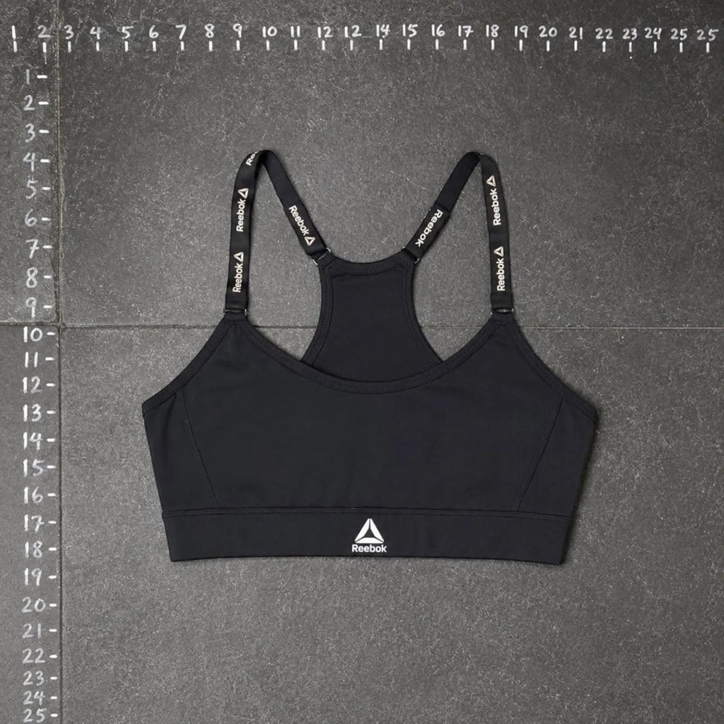 The Room Collective Reebok black logo strap sports bra, size S. Racerback design with performance blend fabric.