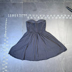The Room Collective black strapless sweetheart mini dress with shirred back and flared skirt.