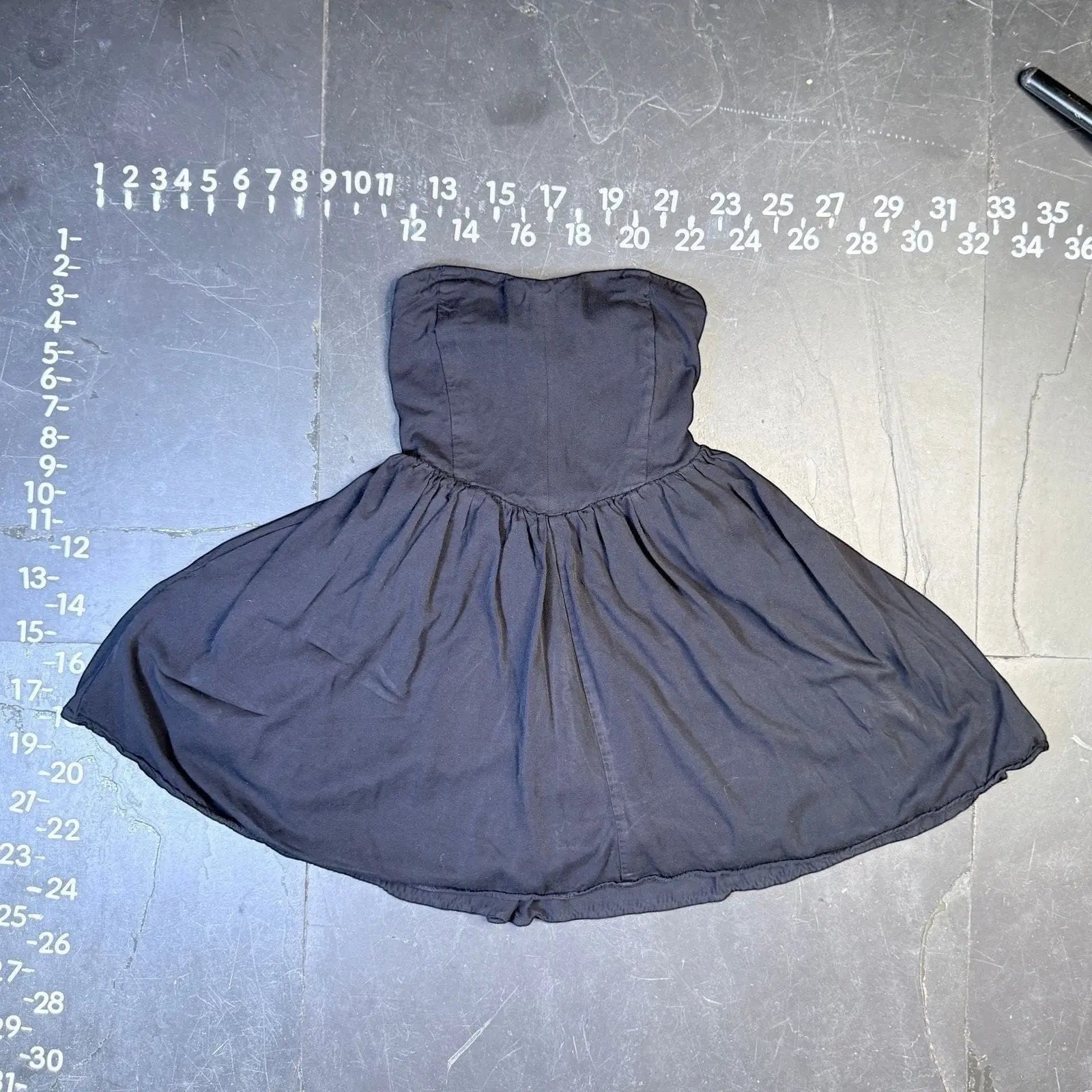 The Room Collective black strapless sweetheart mini dress with shirred back and flared skirt. Size medium.