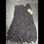 The Room Collective Riley black ruched nylon parachute skirt with adjustable drawstring hem and vintage labels. Size S.