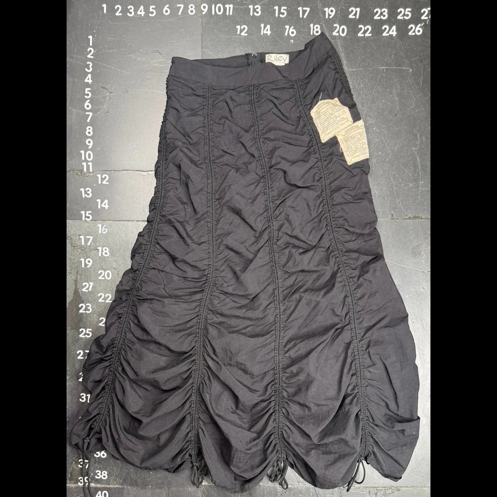 The Room Collective Riley black ruched nylon parachute skirt with adjustable drawstring hem and vintage labels. Size S.