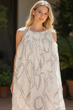 The Room Collective white mini dress with black abstract swirl print, halter neck, and tie-back detail. Lightweight crinkled fabric.