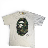 The Room Collective white cotton t-shirt with A Bathing Ape Big Ape Head logo featuring tiger camouflage print.